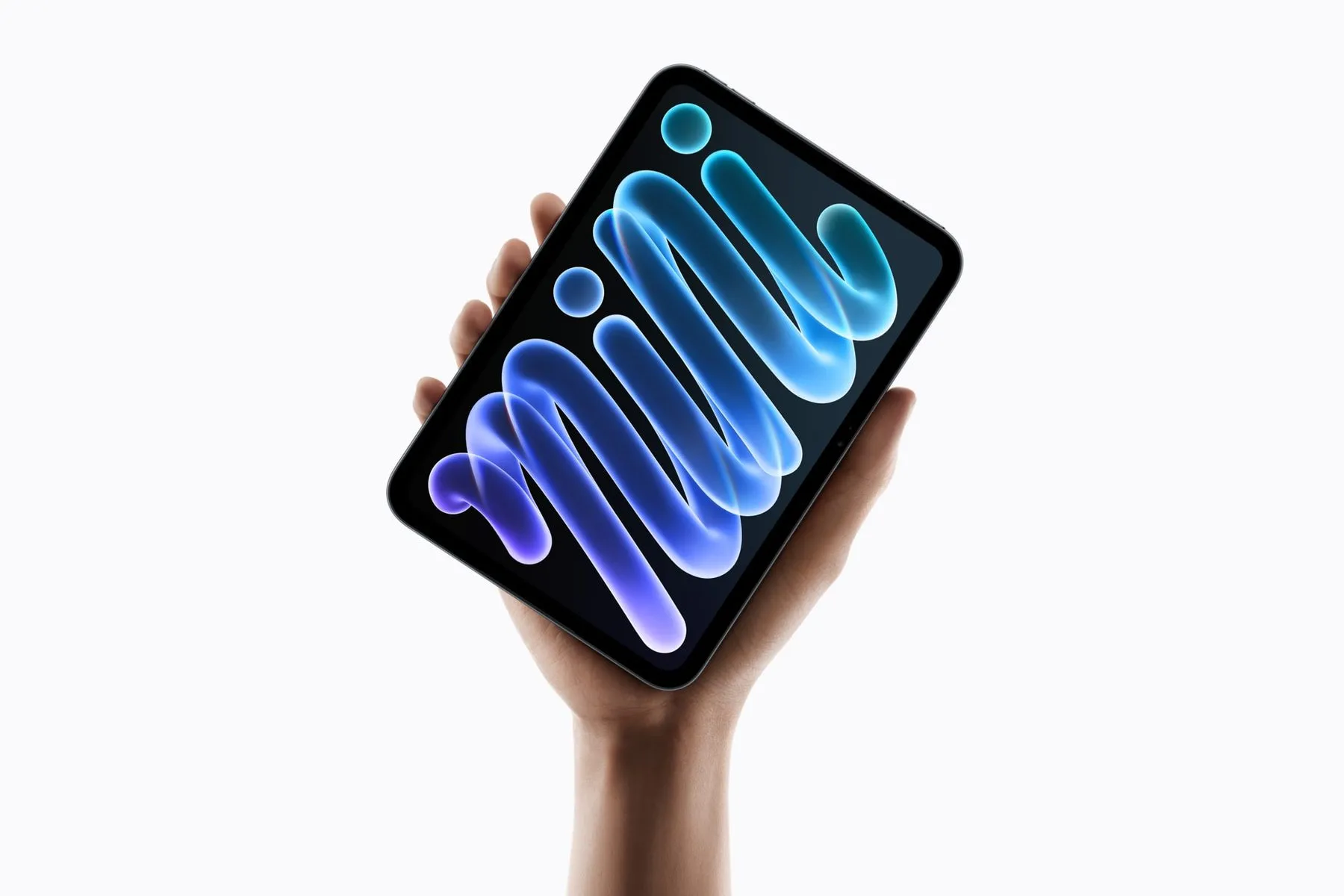 A hand holding the new iPad mini, its dark OLED screen showing a glowing blue and purple 'mini' wallpaper.